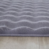 Close-up van zacht grijze tapijt met golvend patroon 3D effect 