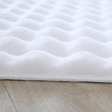 Close-up van zacht wit tapijt met golvend patroon 3D effect 
